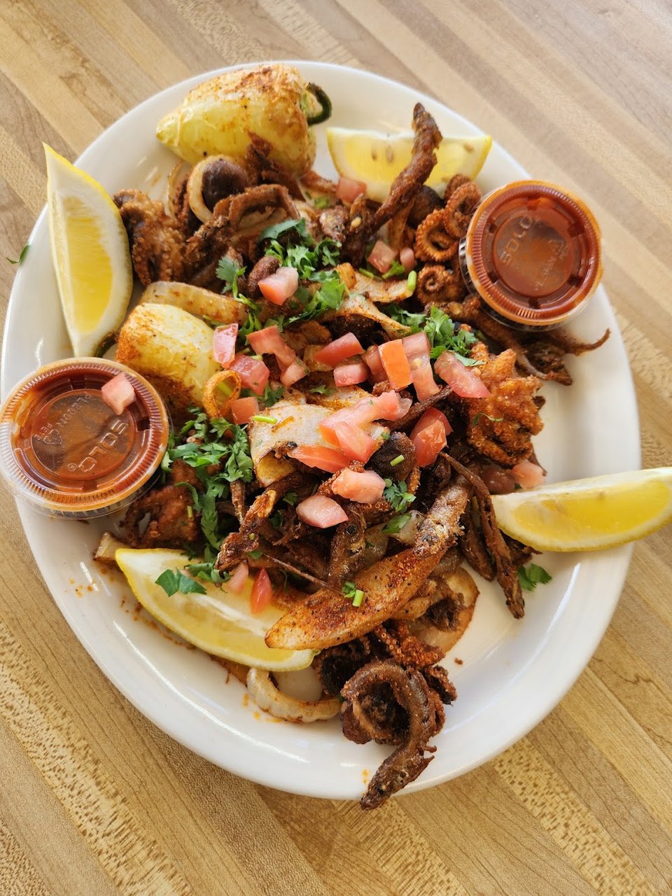 Seafood menu with caldo and tostadas.